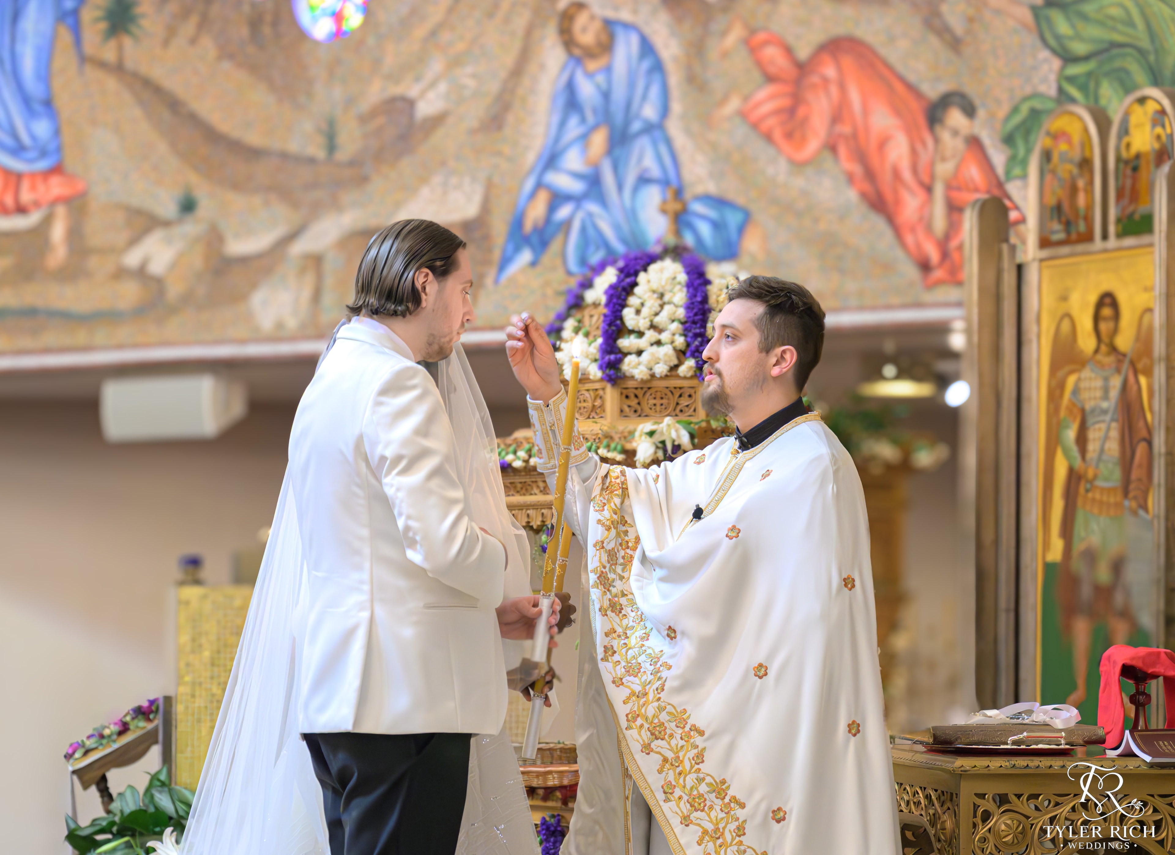 Groom exchanging vows at an orthodox church ceremony