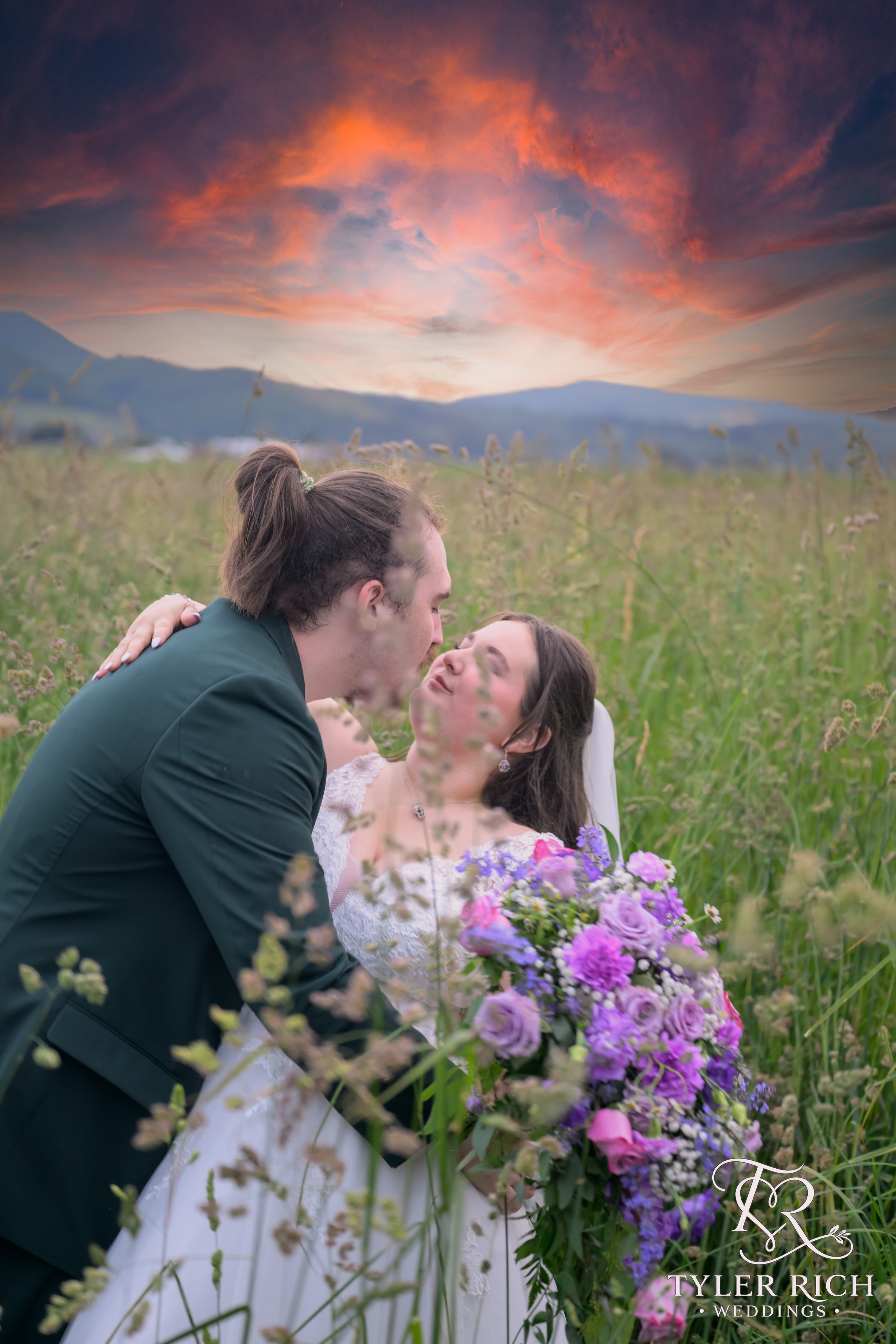 Bride and groom kissing in a wildflower field at sunset