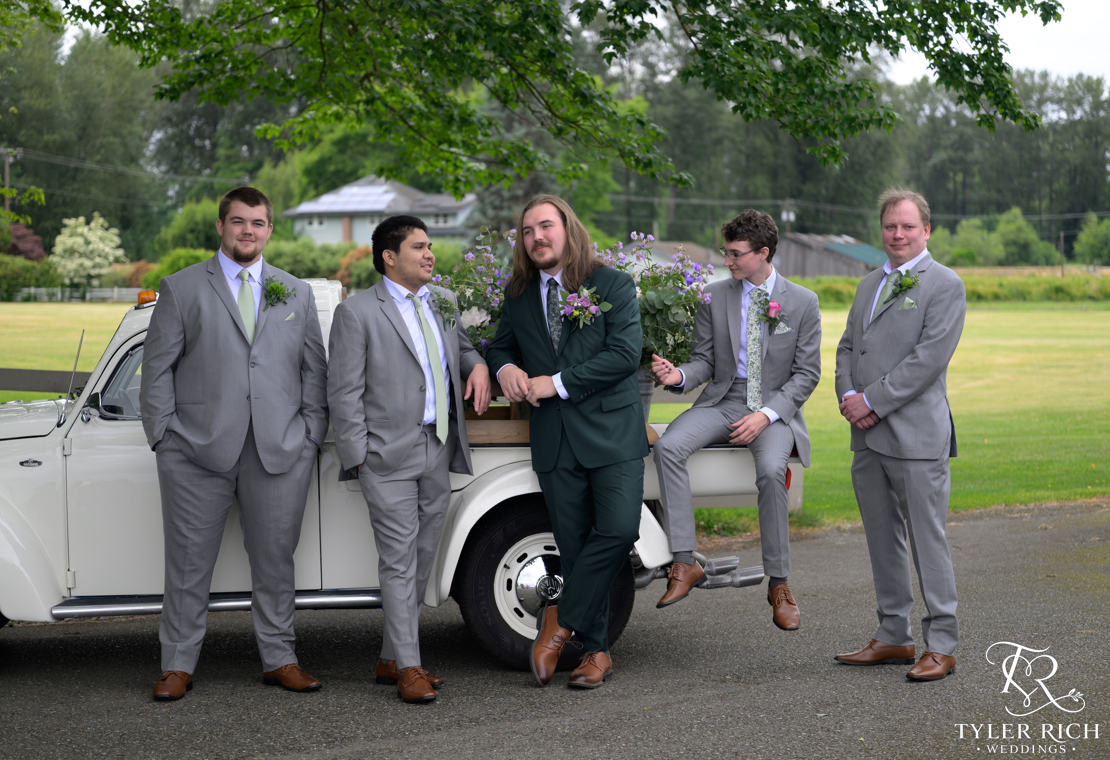 Groom and groomsmen with a vintage truck and florals