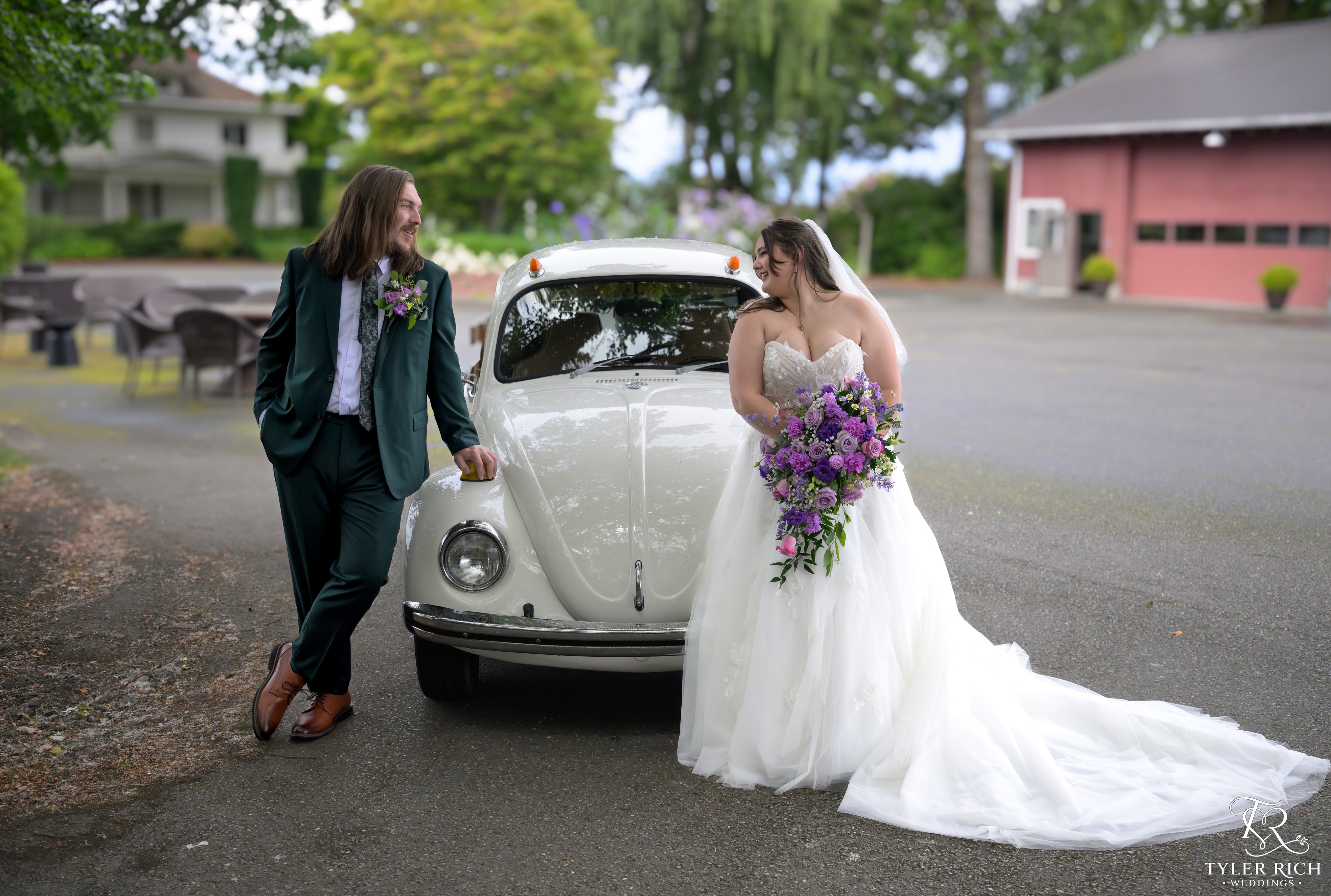 Bride and groom beside a vintage white VW Beetle
