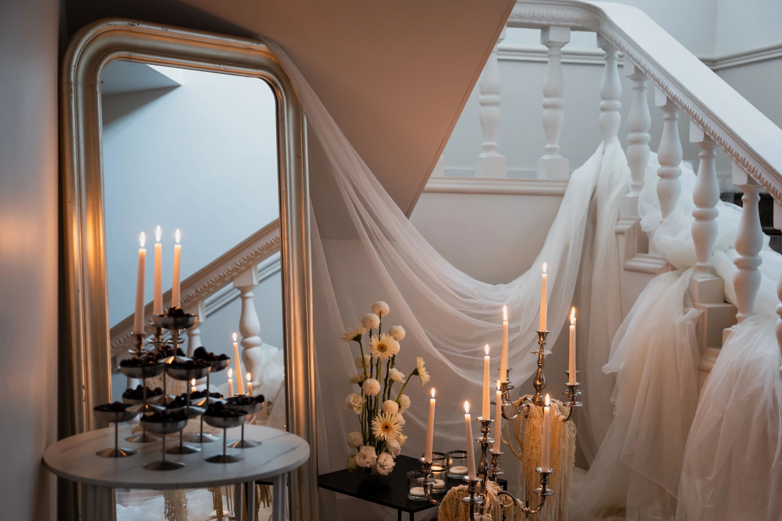 Elegant wedding venue interior with candlelight and staircase