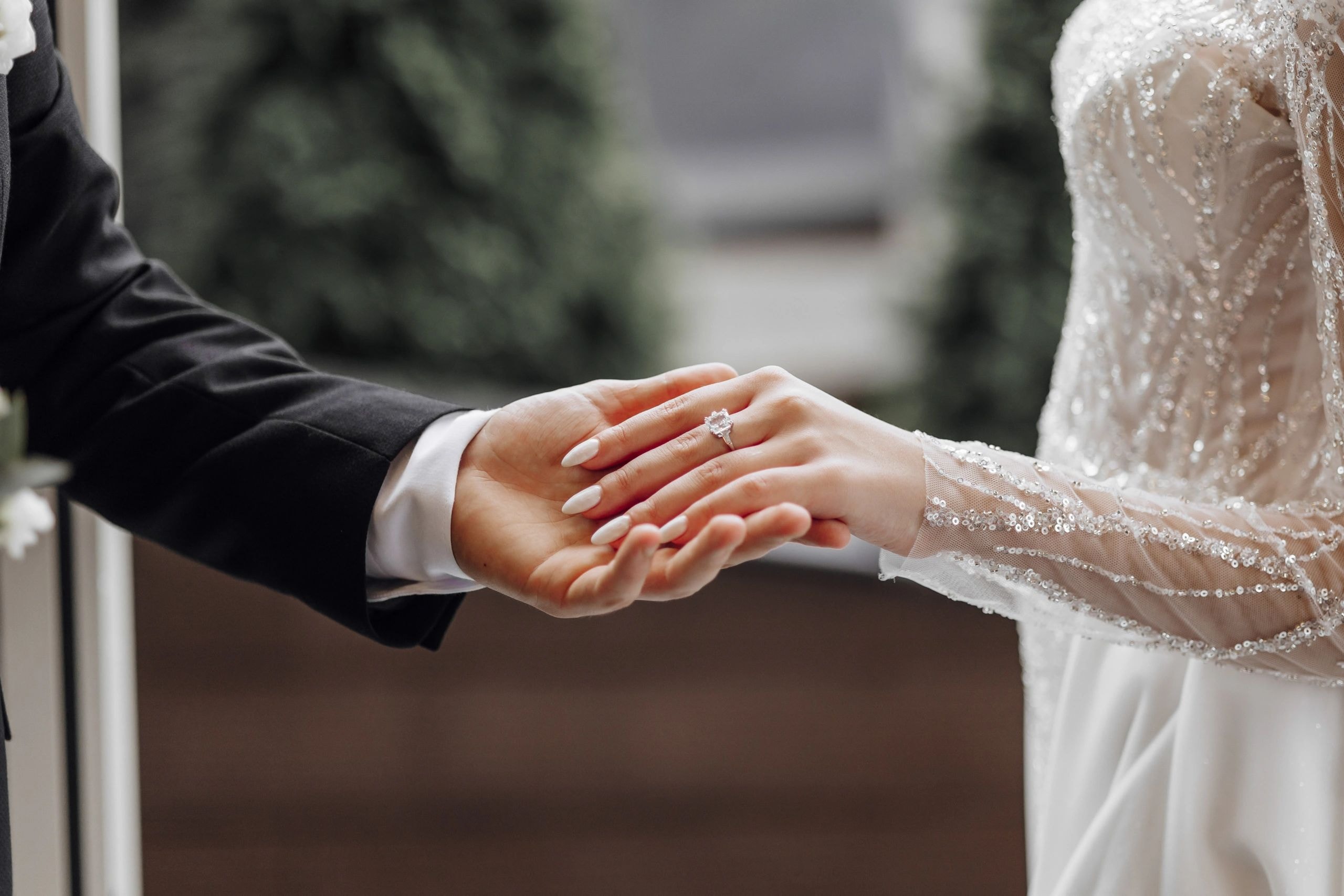 Bride and groom hands with wedding rings